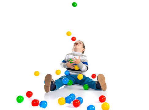Kid playing with colored balls