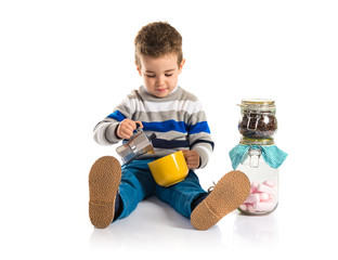 Kid holding a cup of coffee