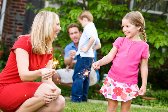 Summer: Mom Teaches Girl to Hold Sparklers