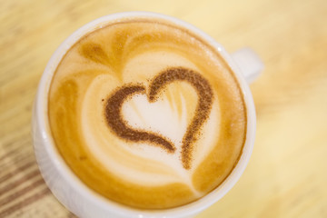 Coffee cup with milk and heart shape