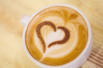 Coffee cup with milk and heart shape