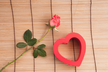 Rose on wood background.