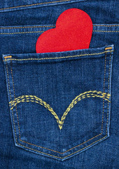 Red heart in blue denim jeans pocket