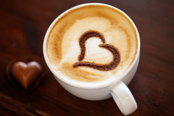 Coffee cup with milk and heart shape