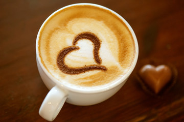 Coffee cup with milk and heart shape