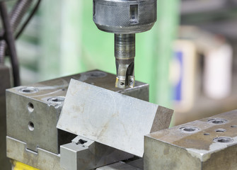 operator cutting steel surface by milling machine