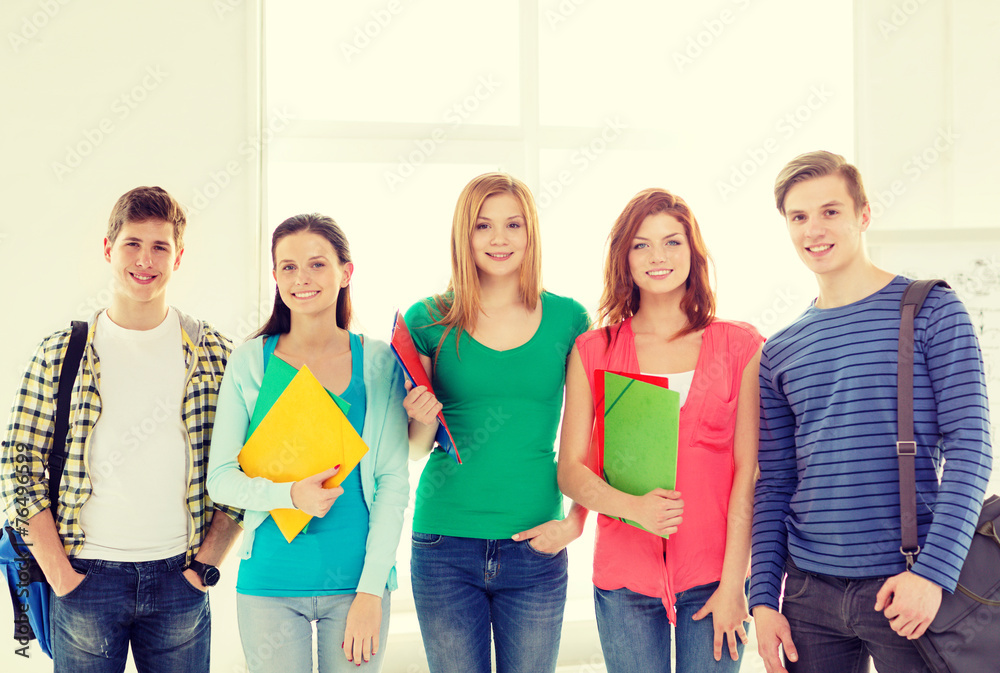 Wall mural smiling students with bags and folders at school