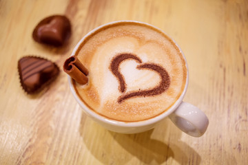 Coffee cup with milk and heart shape