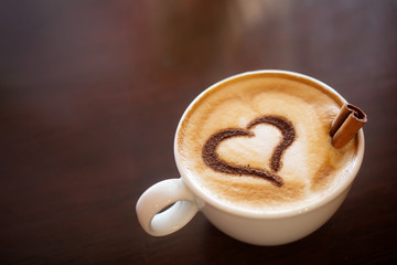 Coffee cup with milk and heart shape