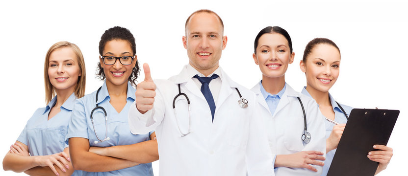 group of smiling doctors with showing thumbs up