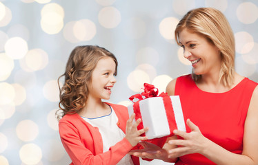 happy mother and daughter with gift box