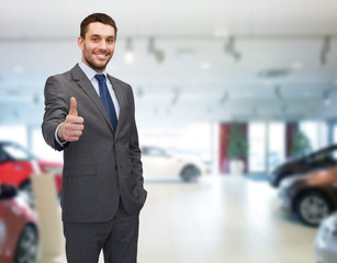 smiling businessman showing thumbs up