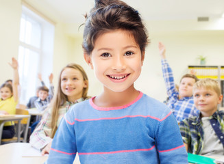 little school girl over classroom background