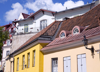 Coloured ancient buildings under the red tiled roof in Tallinn