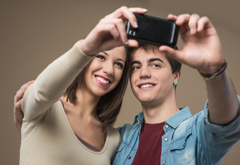 Young couple taking selfies