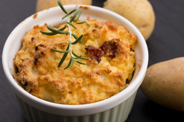 dish of potato souffle with rosemary