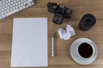 Desktop with camera blank sheet and coffee