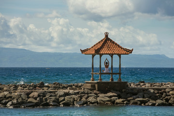 Caucasian woman practicing yoga at seashore