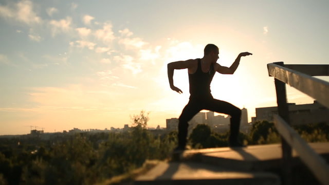 Man dancing at sunset