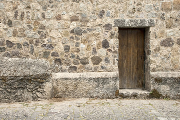 Fototapeta na wymiar Spanish Colonial Style - Wooden Door And Stone Wall