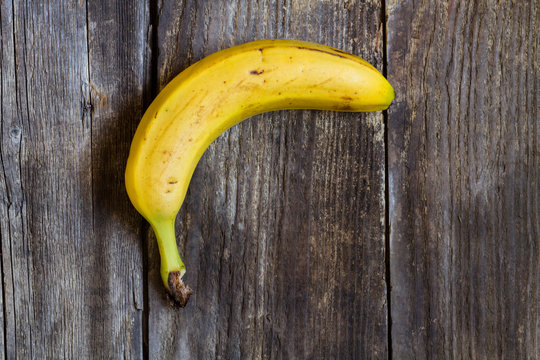 ripe banana over a wooden background - top view