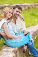 Portrait of happy caucasian Couple Sitting Together Outdoors Whi