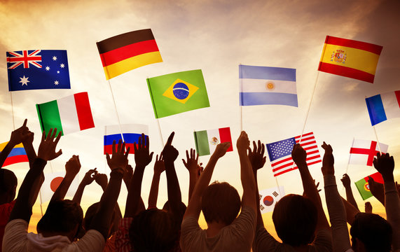 Group of People Waving National Flags in Back Lit Concept