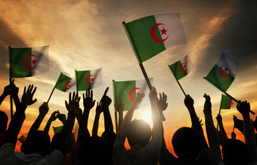Silhouettes People Holding Flag Algeria Concept
