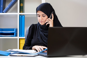 Arab businesswoman watching documents