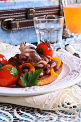 Bruschetta with salad vegetables and octopus