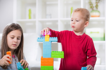 Two children play with cubes