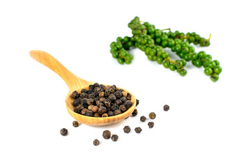 Black pepper in wooden spoon