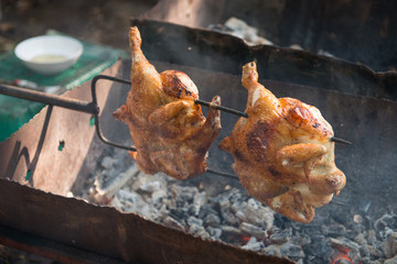Grilled chicken skewers over stove