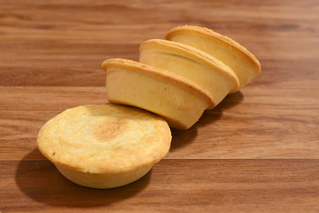 Freshly baked meat pies with sauce