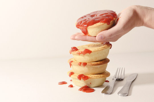 Freshly baked meat pies with sauce