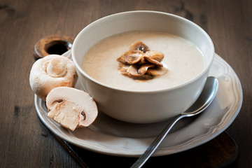 Mushroom cream soup on a wooden background © elena_siberia