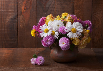 Still life with colourful chrysanthemums bunch  on wooden table