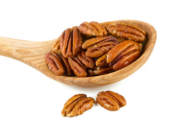 pecan nuts in a wooden spoon