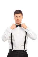 Confident young man adjusting his bow-tie