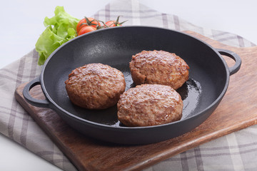 Meat rissoles on the iron pan