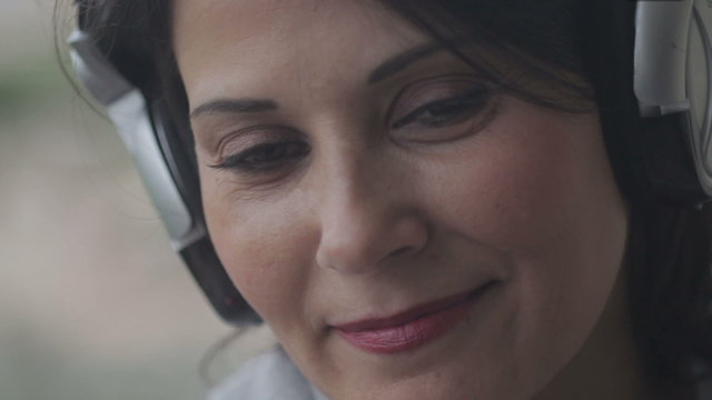 woman smiles with headphones