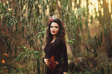 Romantic girl stands in the park and looking at the camera.