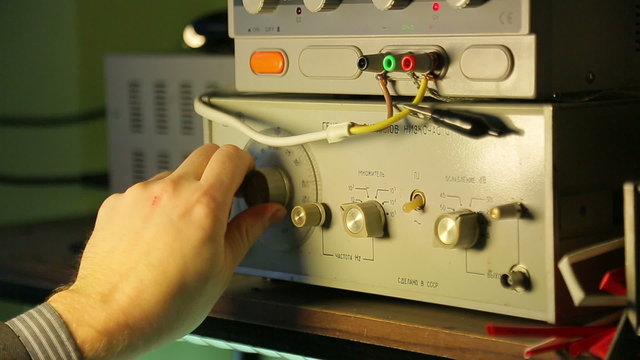 Low-frequency signal generator, a scientist controls