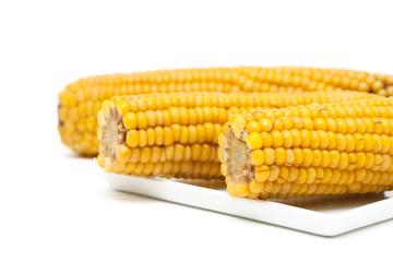 boiled corn on the cob on a white background