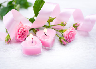 Fototapeta na wymiar Valentine's Day. Pink heart shaped candles and rose flowers