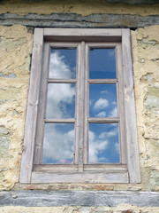 Fototapeta na wymiar Reflection Of The Sky On An Old Window