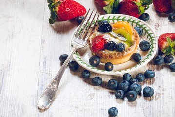 Delicious cookie made shortcrust pastry with fresh fruit, strawb