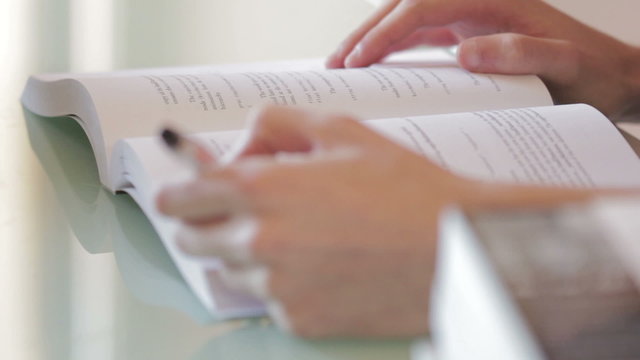 Male (hands) reading a book, closeup