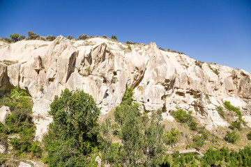 Fototapeta na wymiar Canyon walls with man-made caves in the National Park of Goreme
