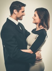 Happy smiling couple in suit and dress